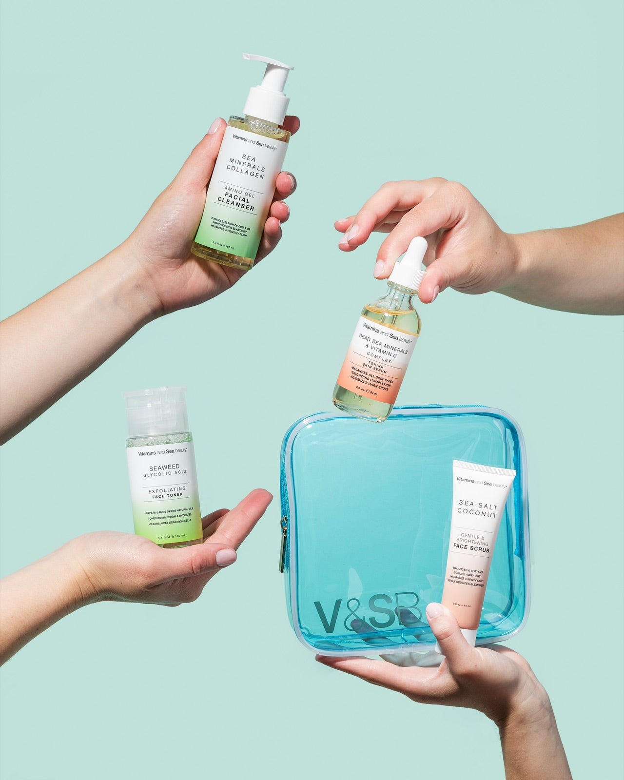 Hands holding Vitamins and Sea beauty cleanser, serum and toner over a blue travel bag